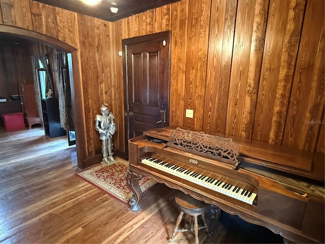 miscellaneous room with hardwood / wood-style flooring, crown molding, and wood walls