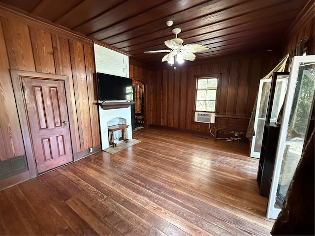 unfurnished living room featuring dark hardwood / wood-style flooring, wood ceiling, ceiling fan, cooling unit, and wood walls