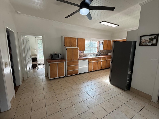 kitchen with black fridge, white dishwasher, light tile patterned flooring, and ceiling fan