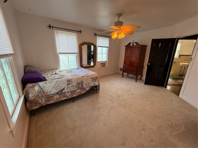 carpeted bedroom featuring connected bathroom and ceiling fan