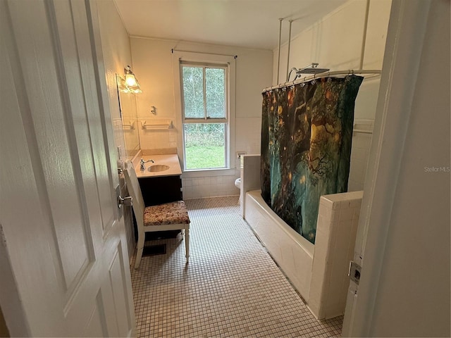 full bathroom with tile patterned floors, shower / bath combo with shower curtain, vanity, and toilet