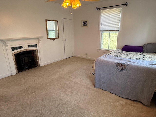 carpeted bedroom with a fireplace