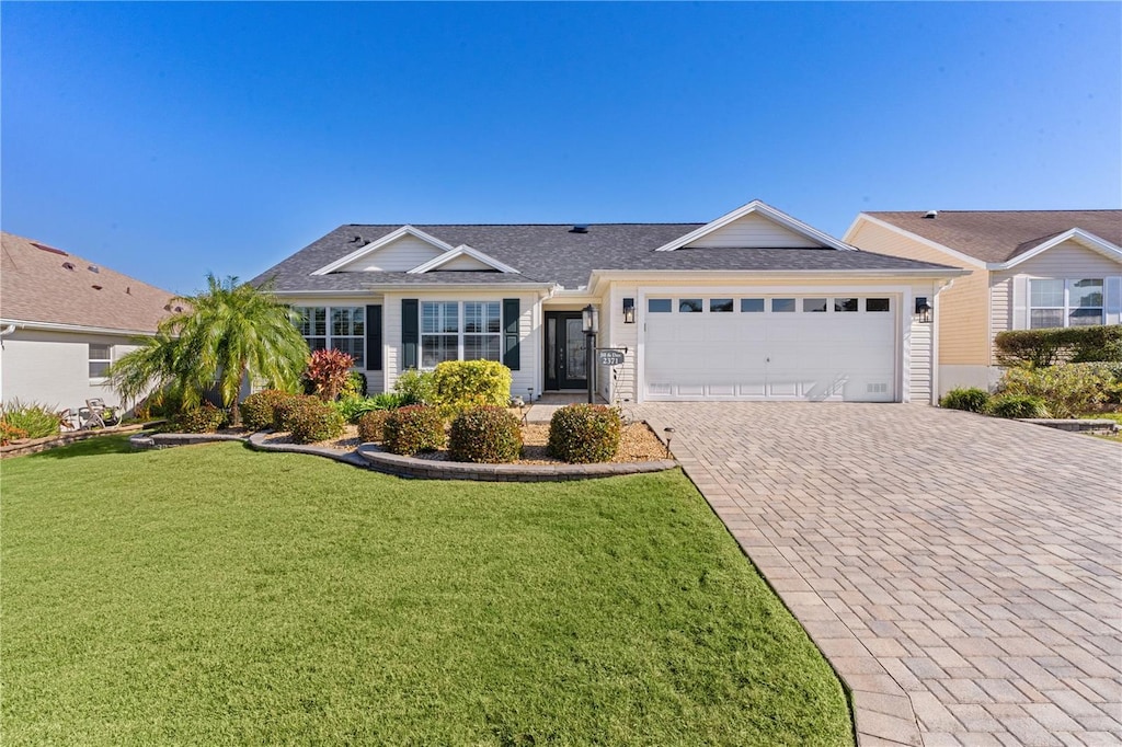 single story home with a garage and a front yard