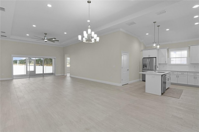 kitchen with sink, hanging light fixtures, a kitchen island with sink, white cabinets, and appliances with stainless steel finishes