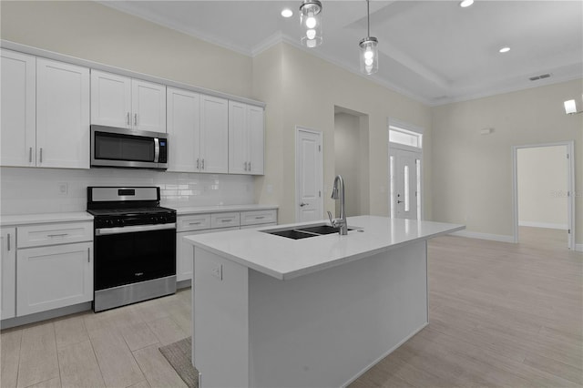 kitchen featuring white cabinets, appliances with stainless steel finishes, and sink