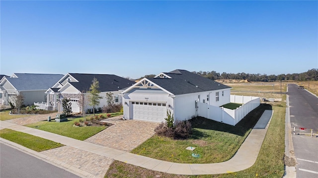 view of front of home featuring a front yard and a garage