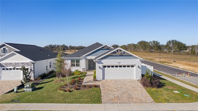 view of front of home featuring a front yard and a garage