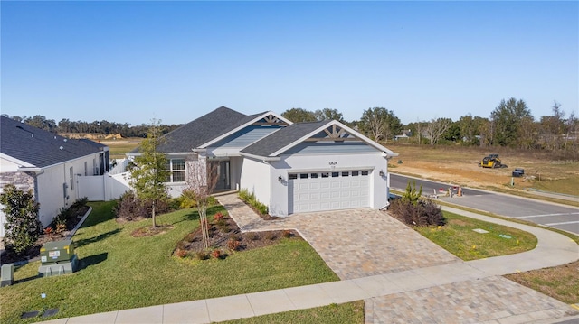 view of front facade featuring a front yard and a garage