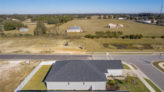 birds eye view of property with a rural view