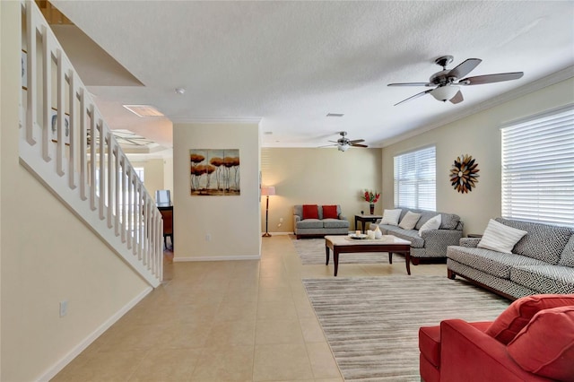 tiled living room with crown molding, ceiling fan, and a textured ceiling