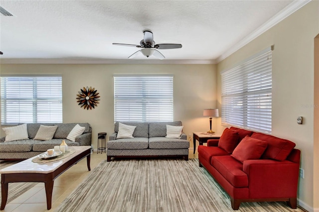 living room with a textured ceiling, ceiling fan, and ornamental molding