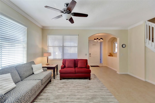 living room featuring ceiling fan with notable chandelier and ornamental molding