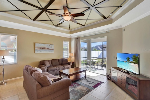 tiled living room featuring a raised ceiling, ceiling fan, and ornamental molding