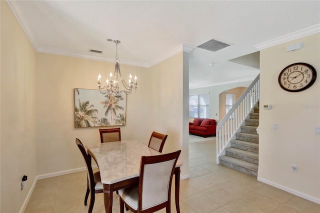 dining area featuring light tile patterned floors, crown molding, and an inviting chandelier