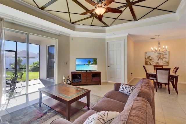 tiled living room with a tray ceiling, crown molding, and ceiling fan with notable chandelier