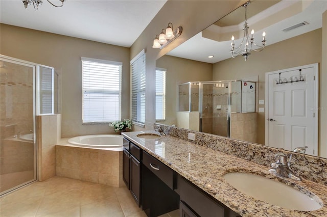 bathroom with plus walk in shower, tile patterned floors, vanity, and an inviting chandelier