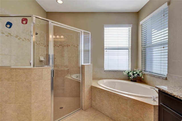 bathroom featuring tile patterned floors, vanity, and shower with separate bathtub