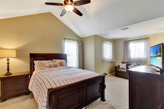 bedroom with ceiling fan, light carpet, and multiple windows