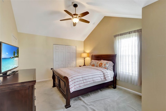 carpeted bedroom featuring ceiling fan, vaulted ceiling, and a closet