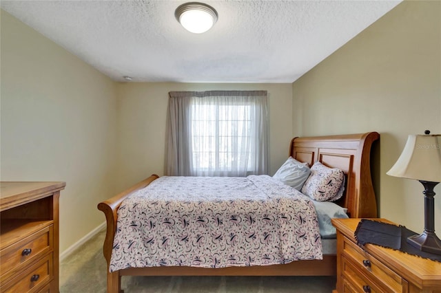 bedroom with carpet floors and a textured ceiling