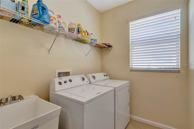 washroom with washer and clothes dryer, sink, and light tile patterned flooring