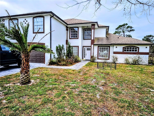 view of front of property with a garage and a front yard