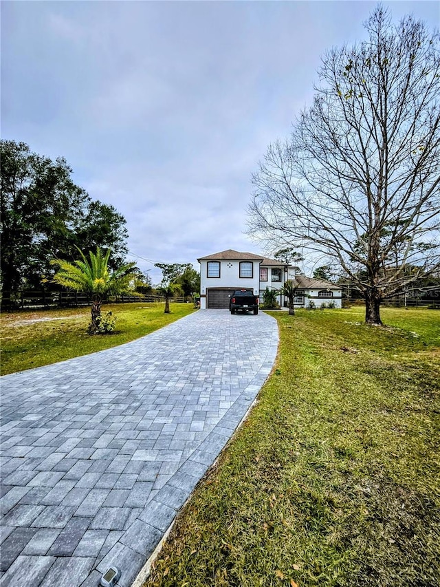 view of front facade featuring a garage and a front lawn