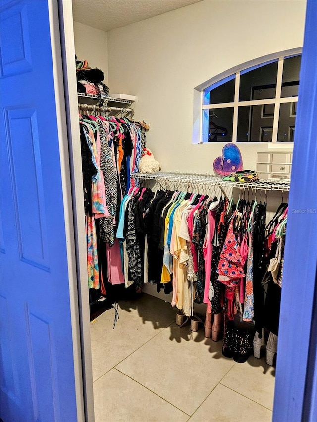 spacious closet with tile patterned floors