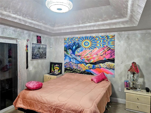 bedroom featuring a tray ceiling and ornamental molding