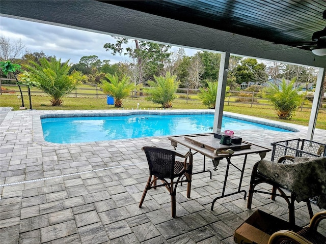 view of pool with ceiling fan and a patio area