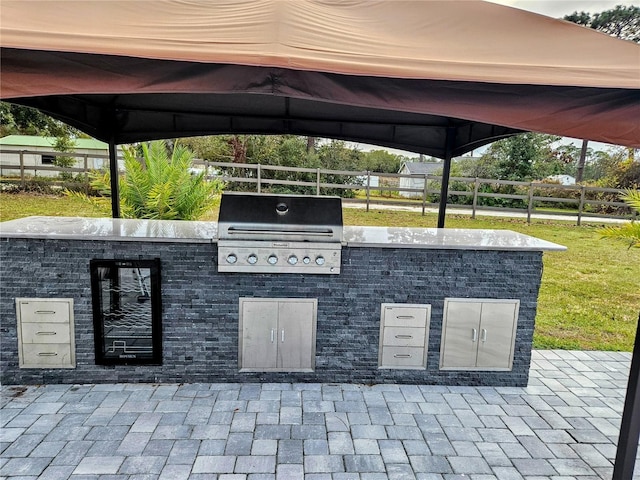 view of patio / terrace featuring a gazebo, area for grilling, and a grill