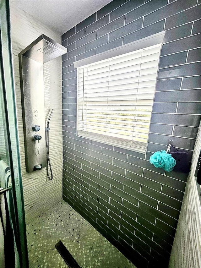 bathroom with tiled shower