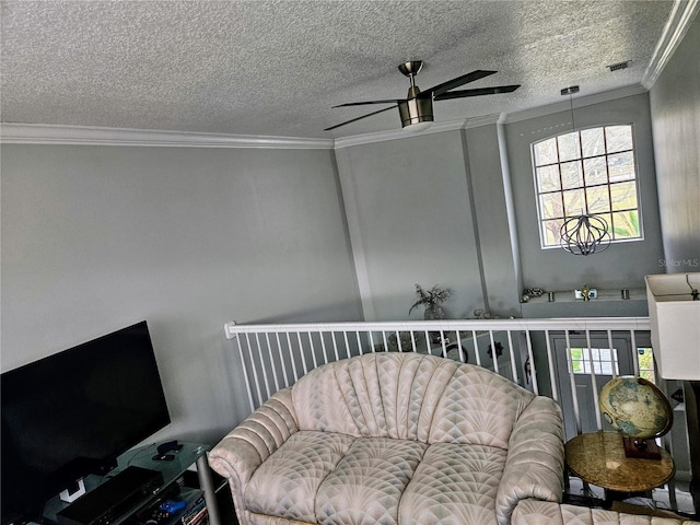 sitting room with ceiling fan, plenty of natural light, and ornamental molding