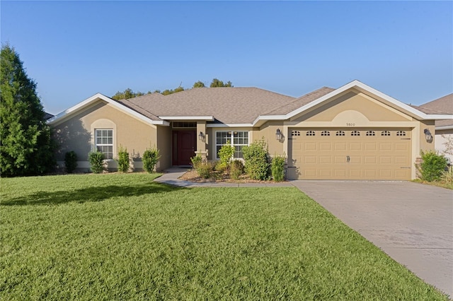 ranch-style house featuring a garage and a front yard