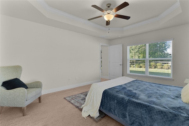 bedroom with carpet floors, a tray ceiling, ceiling fan, and crown molding