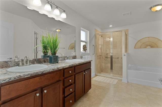 bathroom featuring tile patterned flooring, vanity, and walk in shower