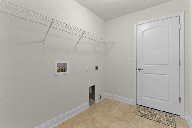 clothes washing area with electric dryer hookup, light tile patterned floors, and hookup for a washing machine