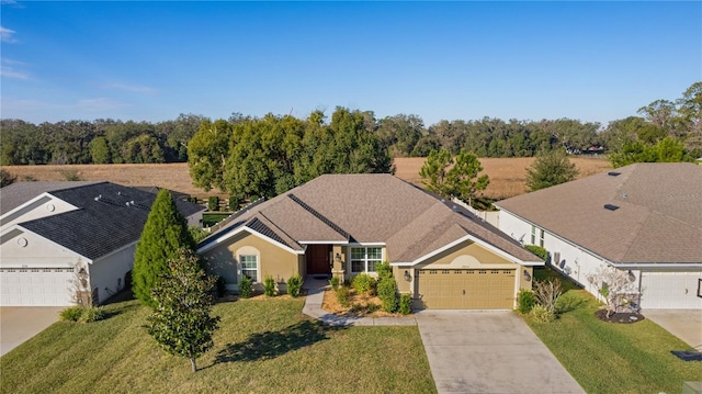 view of front of home with a front yard and a garage