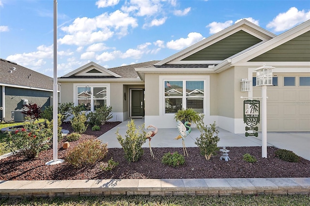 view of front of house with cooling unit and a garage