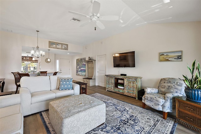 living room featuring ceiling fan with notable chandelier, dark hardwood / wood-style floors, and lofted ceiling