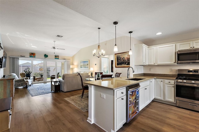 kitchen featuring appliances with stainless steel finishes, white cabinetry, wine cooler, and sink