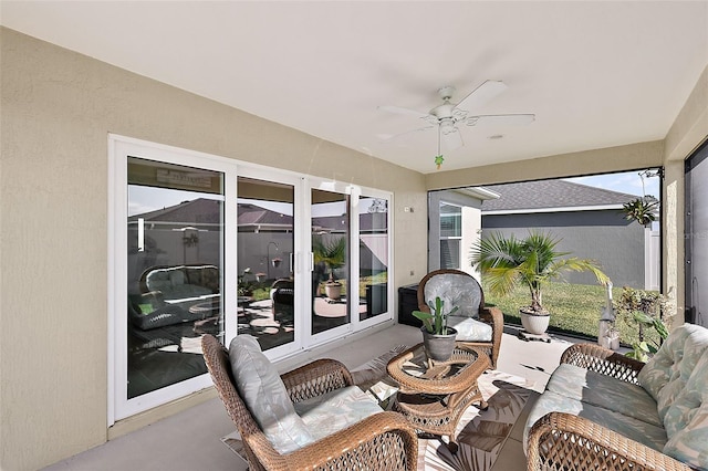 sunroom / solarium featuring ceiling fan