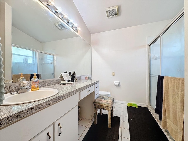 bathroom featuring vanity, lofted ceiling, tile patterned floors, toilet, and a shower with shower door