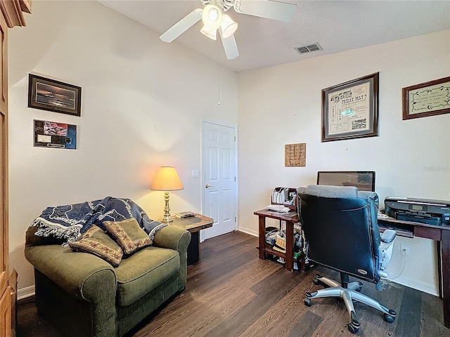 office space featuring a textured ceiling, ceiling fan, lofted ceiling, and dark wood-type flooring