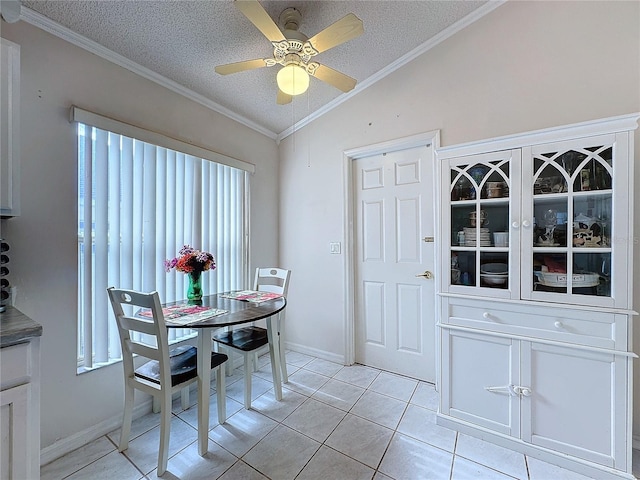 dining area featuring light tile patterned floors, a textured ceiling, and lofted ceiling