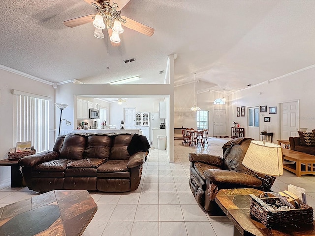 living room with ceiling fan, crown molding, a textured ceiling, lofted ceiling, and light tile patterned floors