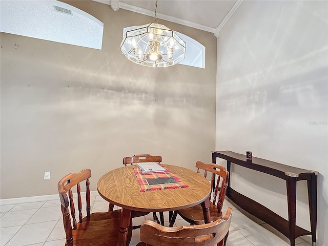 tiled dining room featuring a notable chandelier and crown molding