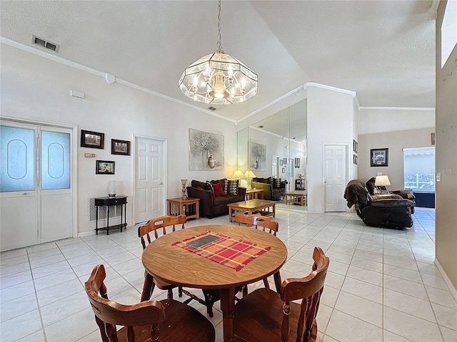 dining room with light tile patterned floors, a textured ceiling, vaulted ceiling, and crown molding