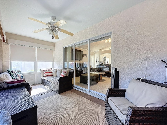 sunroom with ceiling fan and lofted ceiling