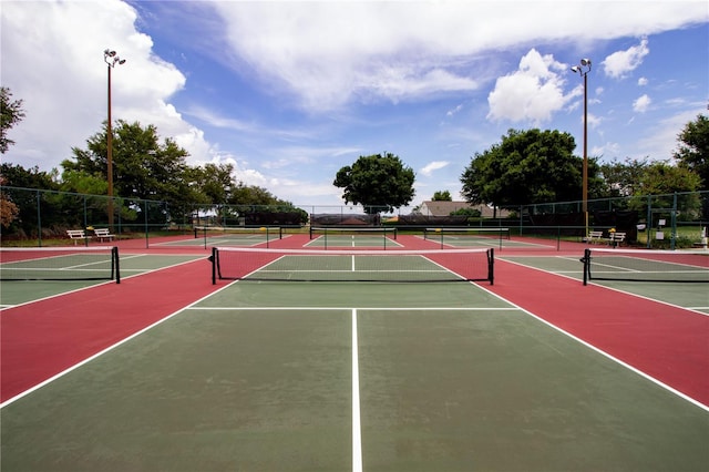 view of tennis court featuring basketball hoop